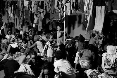 Eritrean migrants, who were rescued at sea by a ship hired by MSF are seen on deck