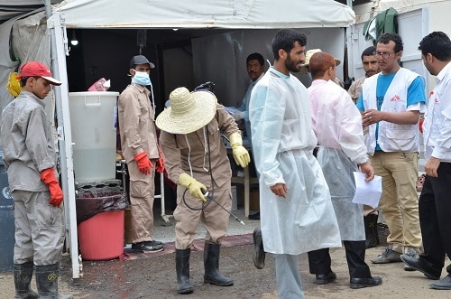 MSF cleaner while spreading chlorination at the shoes of one of the nurses as he was getting out of the cholera treatment center. 