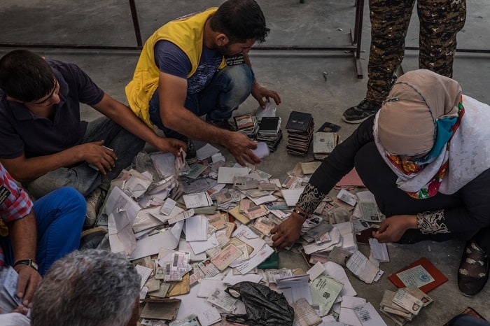 Members of the civil council of Raqqa organise identity cards and passports handed in by those newly arrived at the Ain Issa camp for displaced people in northern Syria. Civilian areas in and around Raqqa have been routinely bombed and deprived of assistance. Access to food and healthcare remains extremely poor, especially in areas undergoing prolonged siege.