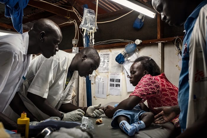August 2017 &ndash; Doctors examine seven-month-old Bless, at the MSF hospital in Aweil, South Sudan. Bakhita (R), who is an MSF midwife in the same hospital, brought her son in suspecting he has malaria.