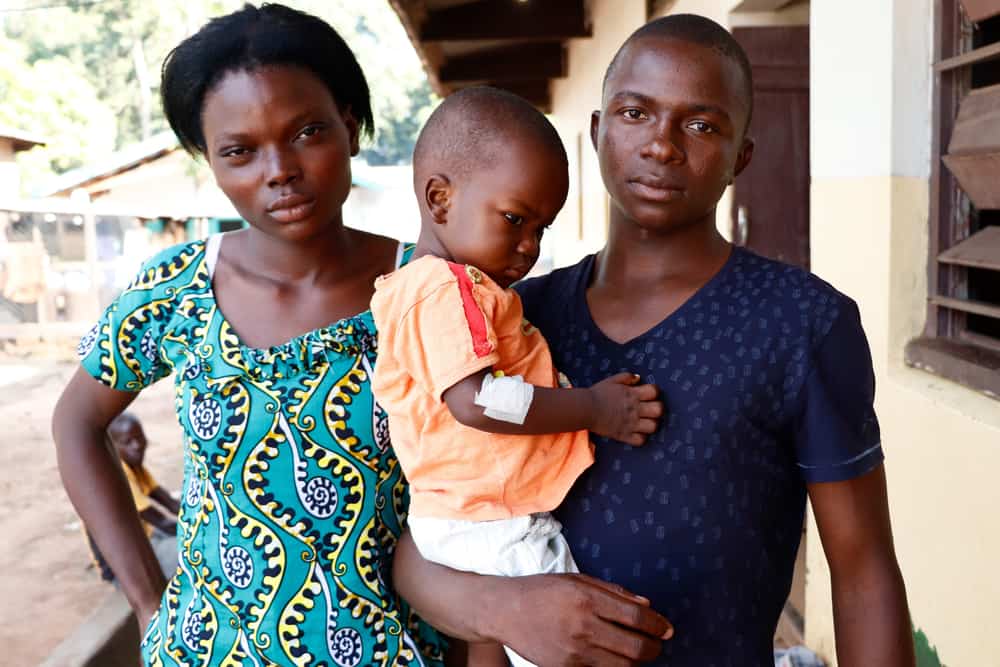 M&eacute;da and Mathuri are pictured with their son Therence outside the pediatric department of Bossangoa&rsquo;s hospital. 