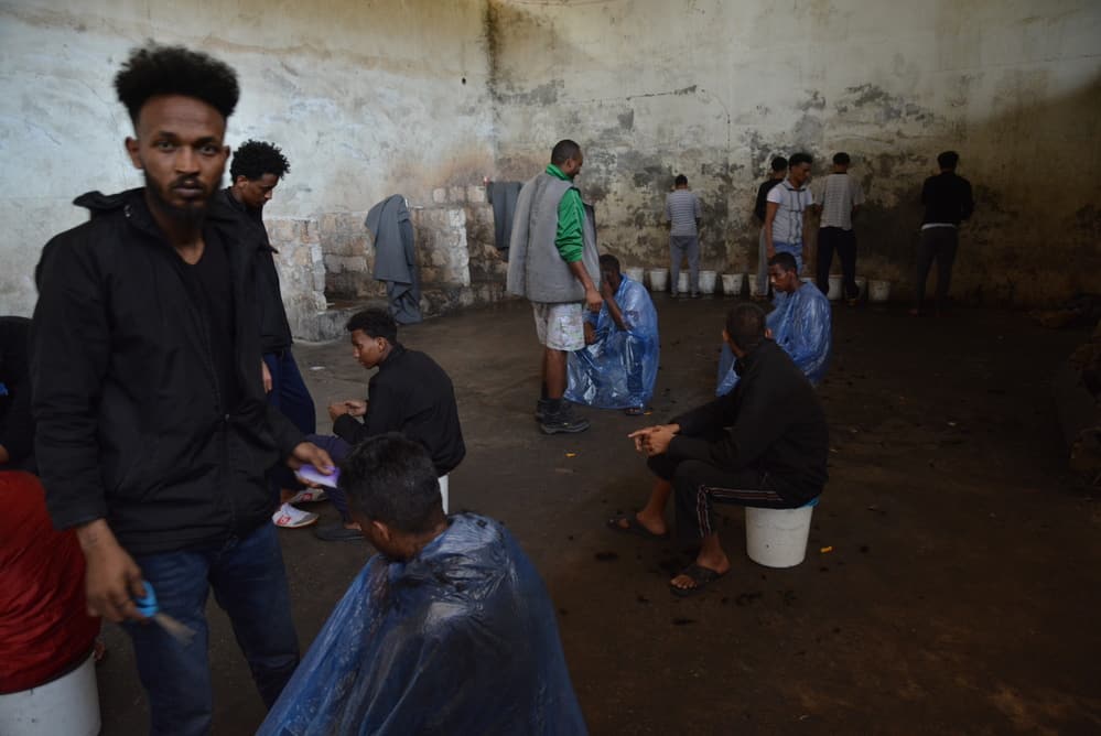 Refugees living among unsanitary conditions in Zintan detention centre. People had access to four barely functioning toilets, buckets to urinate, no shower and only sporadic access to water, which was not suitable for drinking. © JÉRÔME TUBIANA/MSF