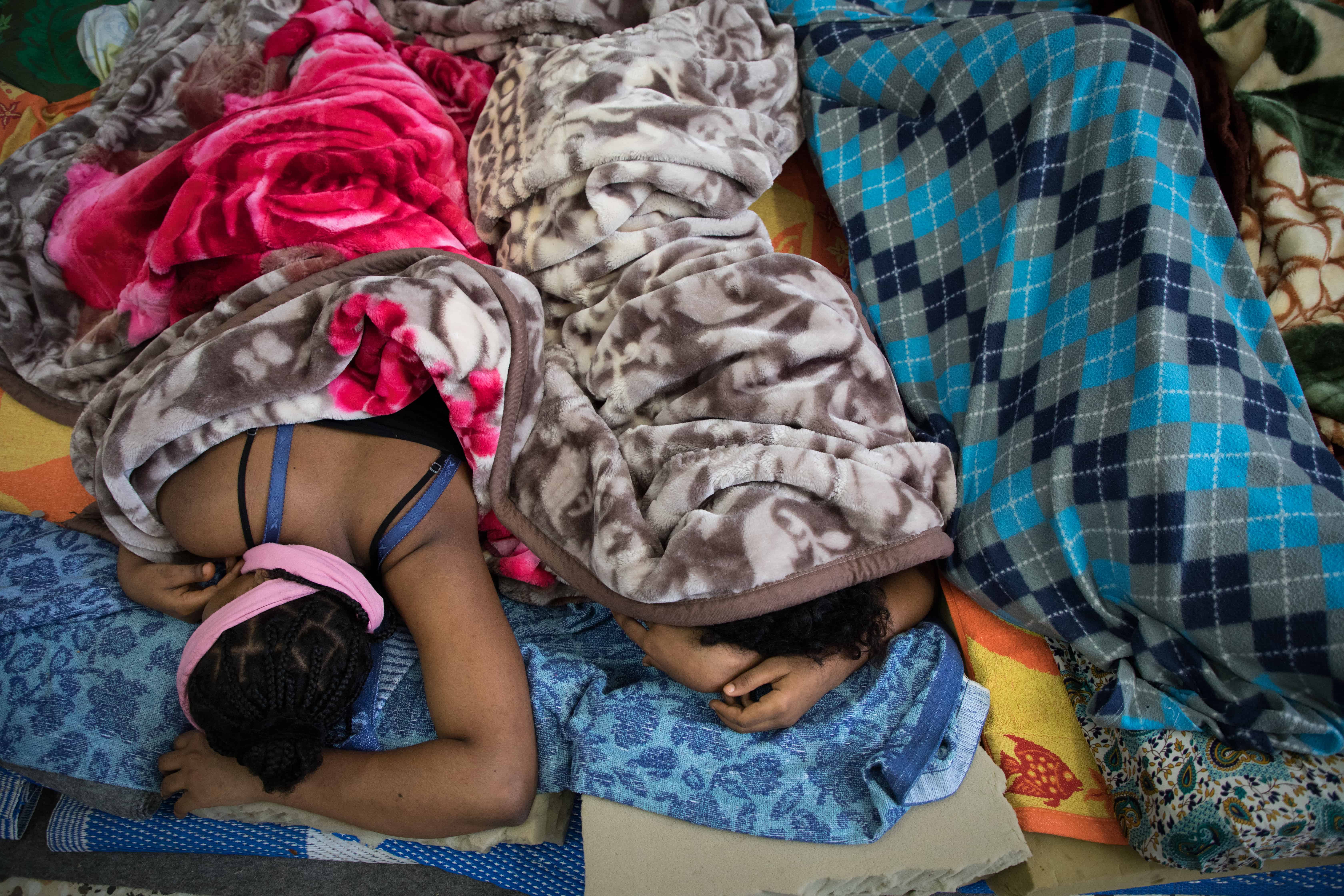 Women detainees take a nap in the Souq Al-Khamis detention centre. Khoms, Libya, October 2019. © AURELIE BAUMEL/MSF