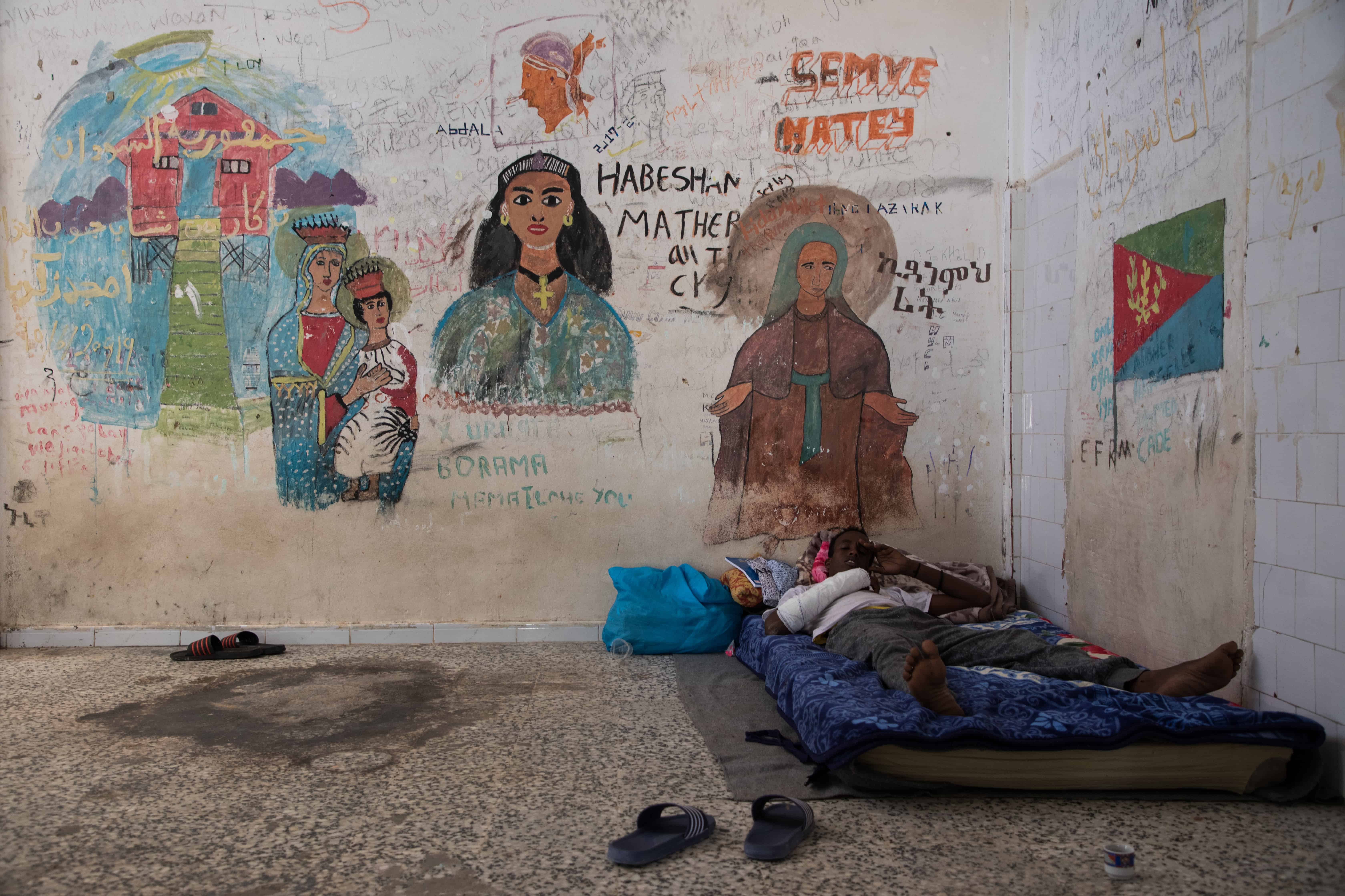 A man gets some rest in the Souq Al-Khamis detention centre, located by the sea in the city of Khoms. Libya, October 2019. © AURELIE BAUMEL/MSF