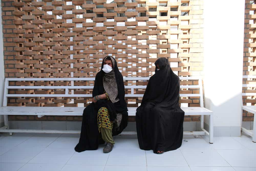 Shamsia sits with her mother in the women’s waiting area of the Médecins Sans Frontières (MSF) drug-resistant tuberculosis (DR-TB) hospital in Kandahar city, Kandahar Province, Afghanistan. Shamsia came to the hospital from the Maiwand district of Kandahar Province. She is in her 9th month of TB treatment.