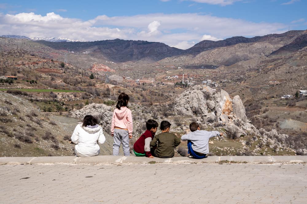 Children gather in Kayatepe (Rezip) village, on the outskirts of Adıyaman. - Children are also having to deal with immense trauma. In psychosocial sessions, some of them draw shattered buildings and sad faces, and recall to counsellors the voices of their loved ones calling for help under the rubbles. Their sense of routine, safety and protection has been shattered. Most of them now lack a physical place they can trust, such as a full-time home and a school. Family members, teachers and friends may no longer be present, as some have been fatally injured or have left to find safety elsewhere. Many children are voicing their fears to their parents but are noticing that the adults they look up to for safety are sad and under acute stress themselves, which adds to family tensions.