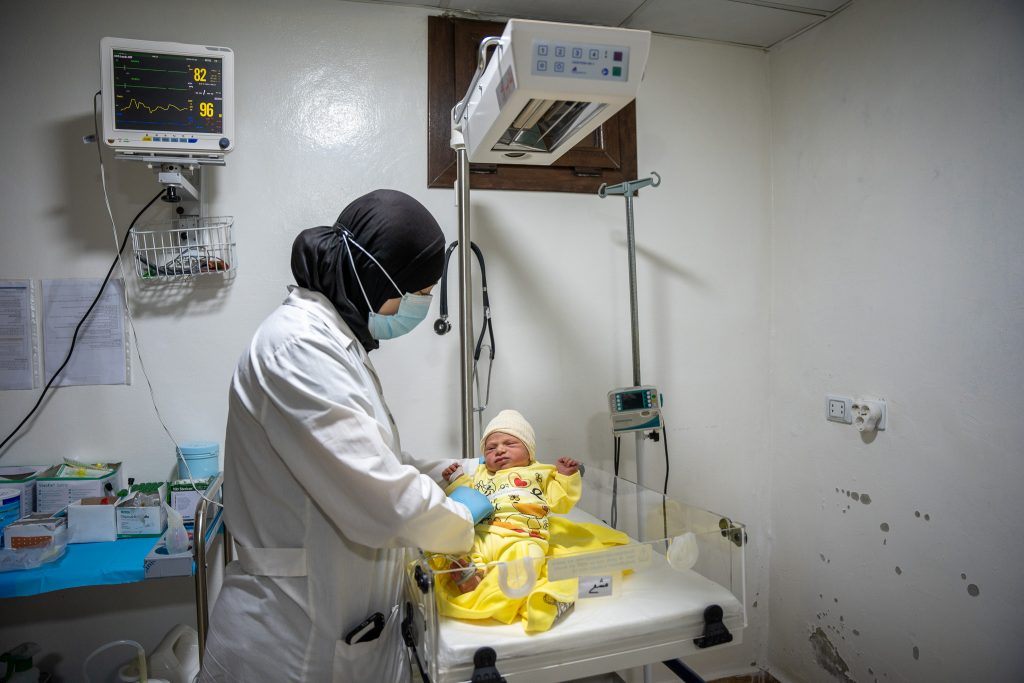 Eman, MSF nurse at Marée maternity hospital checks on a newborn in the neonatal unit of the hospital. 
Northwest Syria, July 2024.