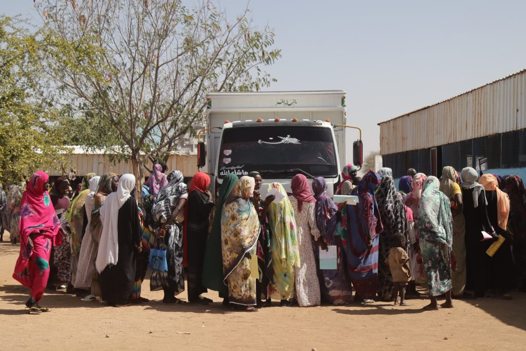 A group of people stand in line to receive the first batch of food and health supplies as part of a targeted food distribution programme by Médecins Sans Frontières (MSF) ©Abdoalsalam Abdallah