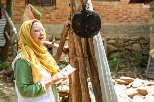 Gazala Basir, Doctors Without Borders India/Médecins Sans Frontières (MSF) community mental health worker speak with a community member during door-to-door outreach in a neighborhood of Tral, Kashmir. They provide information about common mental health conditions and explain the free counseling and support services available through MSF's program in the region.