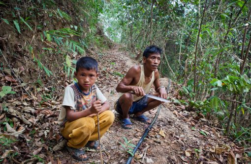 Thongsei Lupho (44) and his wife Mary have seven children. Thongsei is HIV-positive and has been a patient at the MSF clinic in Moreh since 2012. Some of his children are also HIV-positive. Thongsei and his son are going to the "jungle", the nearby forest, to fix the waterpipes that provide water to the village. Even though Thongsei can't work easily as a HIV patient, he does his best to be active in his community. His son is also HIV-positive and receives treatment from the MSF clinic in Moreh.