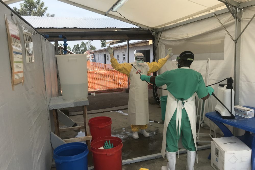 A staff undressing after providing care to patients.